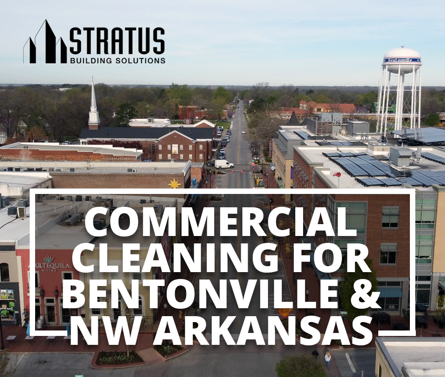 Downtown Bentonville from a drone perspective in the afternoon with the text "Commercial Cleaning now in Bentonville"